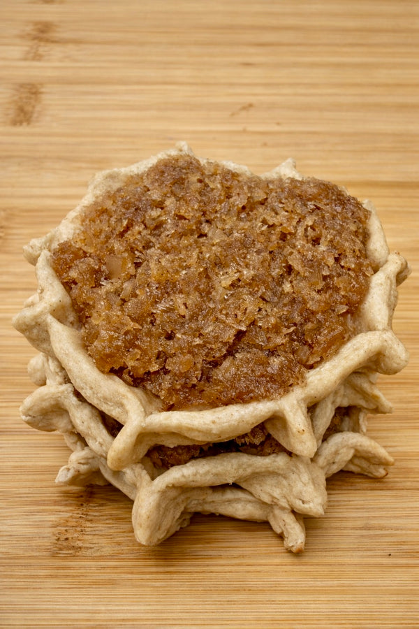 Authentic Jamaican gizzada pastry filled with sweet spiced coconut, freshly baked and packaged for sale. Conyers & Atlanta GA.
