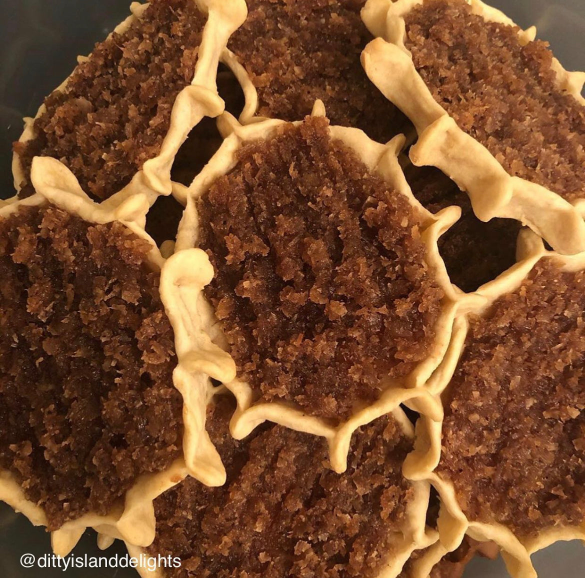 Authentic Jamaican gizzada pastry filled with sweet spiced coconut, freshly baked and packaged for sale. Conyers & Atlanta GA.
